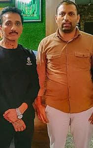 Mumbai Police Crime Branch personnel with Bhavish Bhinde (in black) after arresting him in connection the billboard collapse.