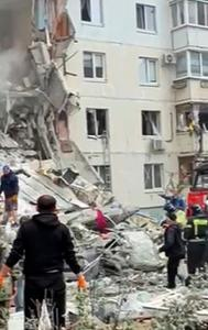 In this photo taken from video, Russian emergency services work at the scene of a partially collapsed block of flats authorities said was hit during an attack by Ukrainian shelling, in Belgorod.
