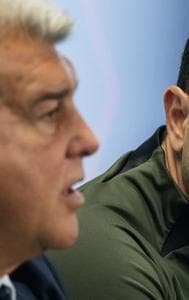 Barcelona’s head coach Xavi Hernandez listens to Barcelona’s president Joan Laporta during a press conference in Barcelona, Spain