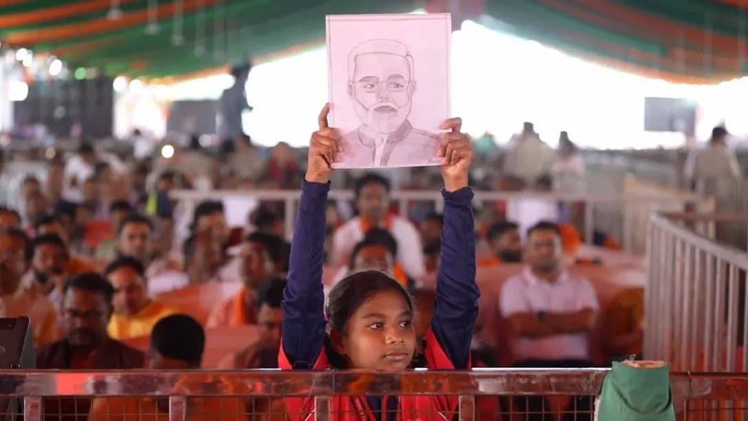 Girl holding PM Modi's Portrait 