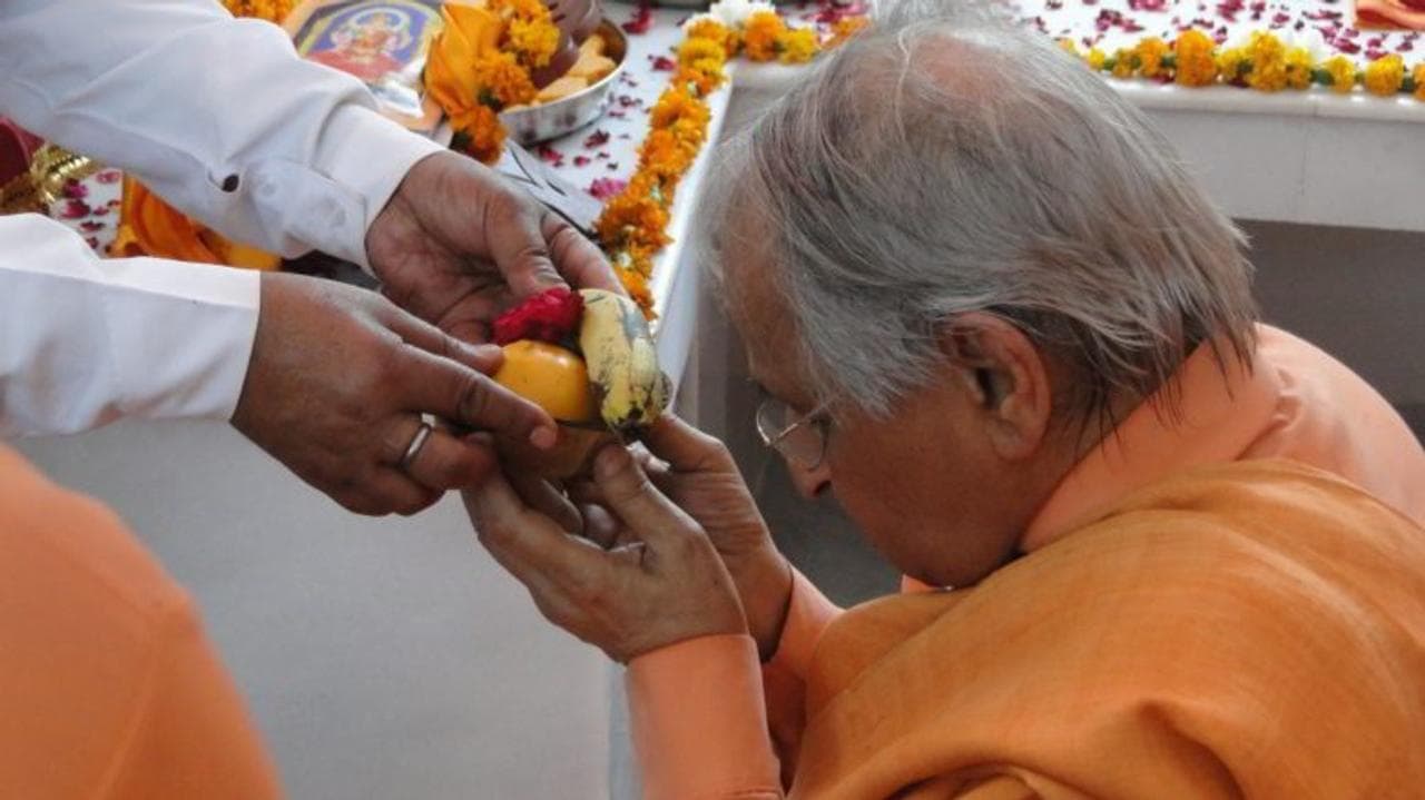 representational image of a man taking prasad