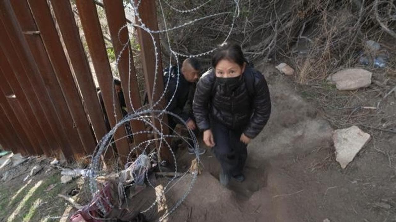 A Chinese immigrant enters the US from a gap in border fencing 60 miles east of San Diego.