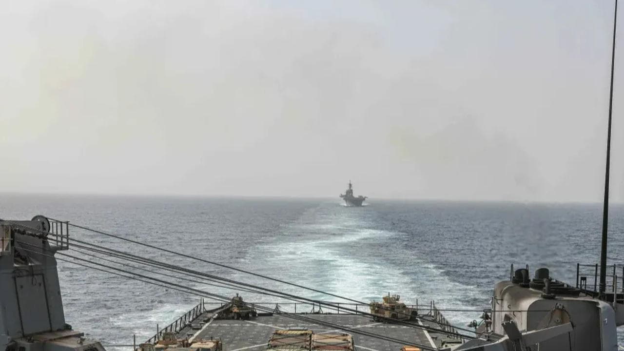 The amphibious dock landing ship USS Carter Hall and amphibious assault ship USS Bataan transit the Bab al-Mandeb strait