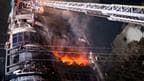 Firefighters work to contain a fire that broke out at a commercial complex in Dhaka, Bangladesh
