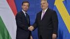 Sweden’s Prime Minister Ulf Kristersson (left) shakes hands with his Hungarian counterpart Viktor Orban in Budapest.