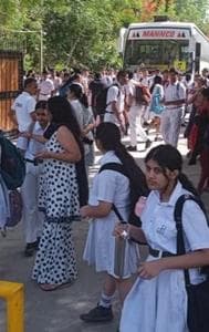  Students and parents outside Delhi Public School, Noida, after several schools received a bomb threat