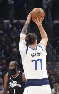 Dallas Mavericks' Luka Doncic in action against Paul George and LA Clipper