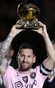 Lionel Messi with his Ballon d'Or trophy