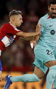Granada’s Bryan Zaragoza pushes Barcelona’s Ilkay Gundogan during a Spanish La Liga soccer match