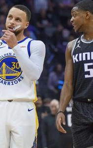 Golden State Warriors' Stephen Curry and Sacramento Kings' De'Aaron Fox