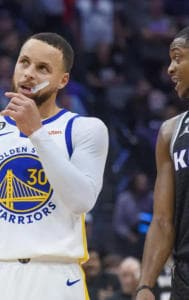 Golden State Warriors' Stephen Curry and Sacramento Kings' De'Aaron Fox