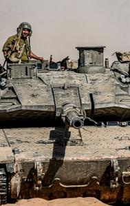 Israeli soldiers drive a tank at a staging ground near the border with the Gaza Strip, in southern Israel, Sunday, May 5, 2024. 