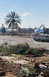 This photo provided by the Israel Defense Forces shows a tank with an Israel flag on it entering the Gazan side of the Rafah border crossing on Tuesday, May 7, 2024. 
