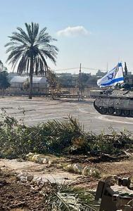 This photo provided by the Israel Defense Forces shows a tank with an Israel flag on it entering the Gazan side of the Rafah border crossing on Tuesday, May 7, 2024. 