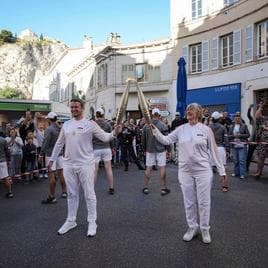 The Olympic flame making its way through the streets of Marseille in France. 