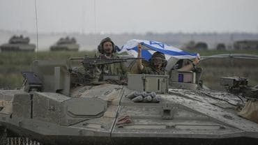 Israeli military marching towards Gaza border fence