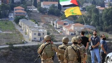 Man waving Hezbollah and Palestine flag 